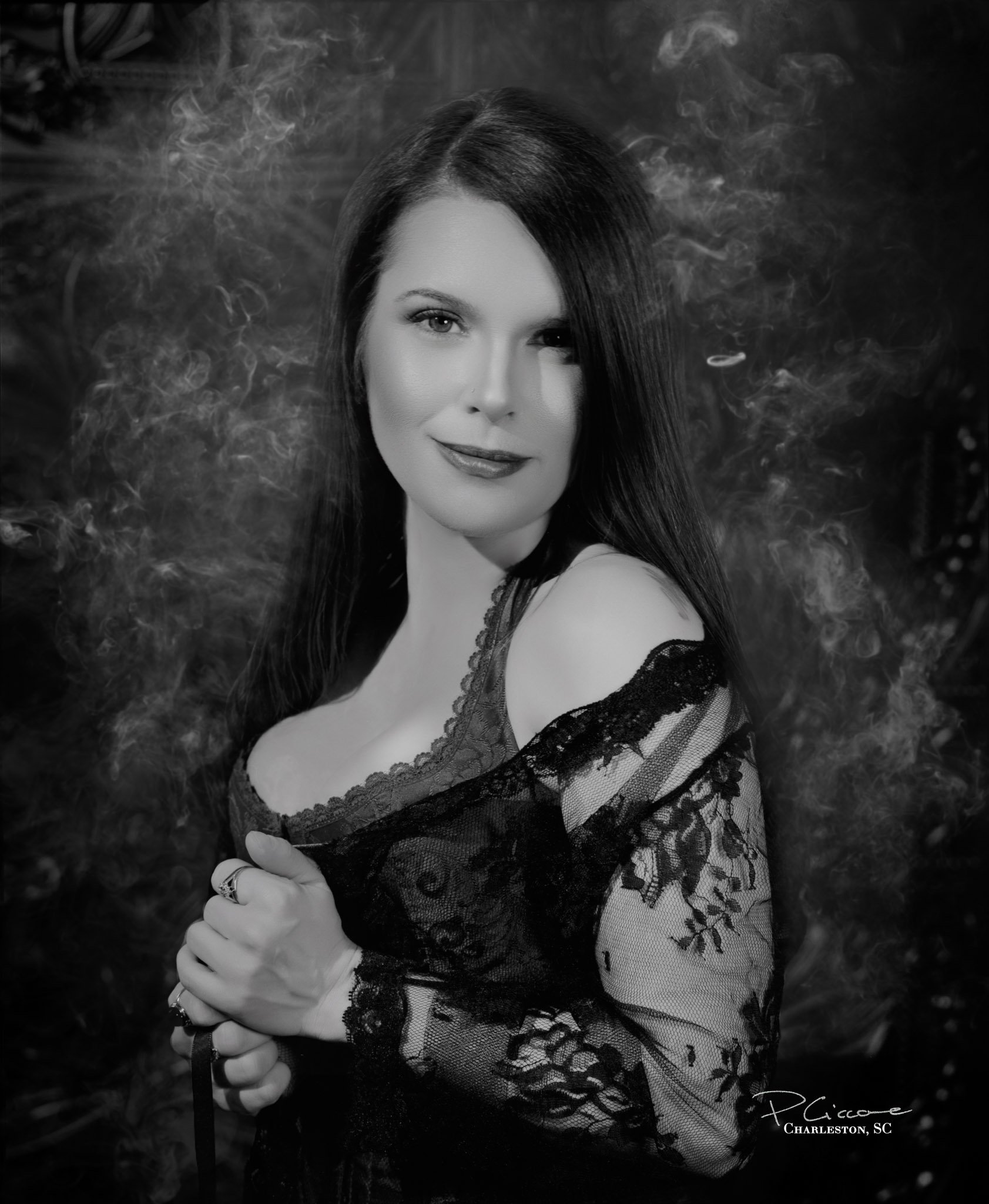 Powerful boudoir portrait in Hollywood-style black and white pf a woman in corset and lace robe. Made by Paolo Portraits in Charleston SC