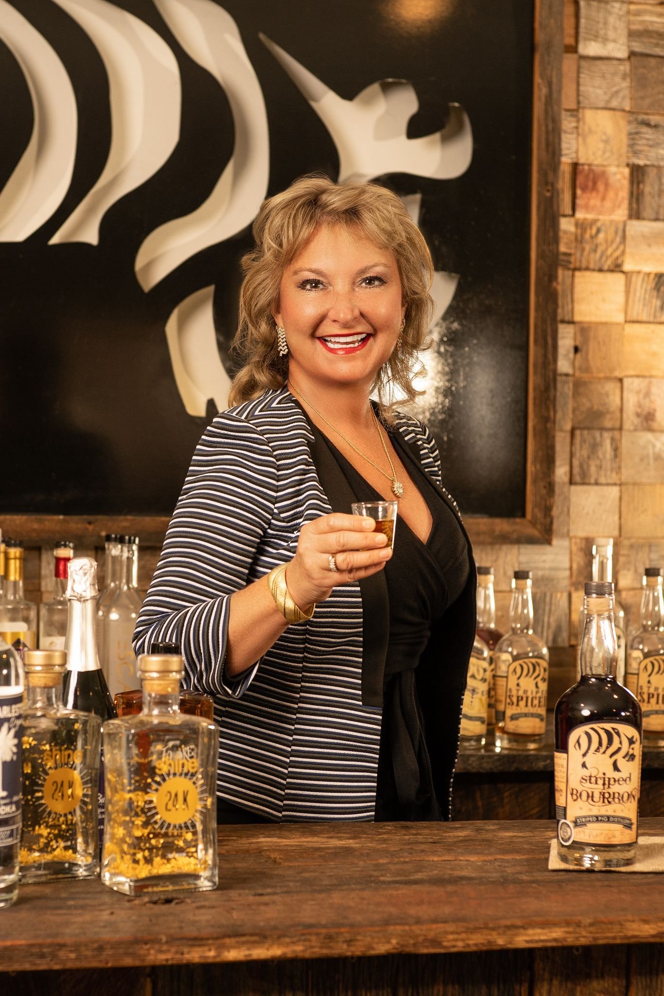 Professional headshot of Paula Dezzutti, CEO of Striped Pig distillery made by Paolo Portraits in Charleston SC